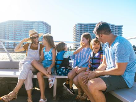 Family with kids on a dolphin cruise in the waters of Orange Beach