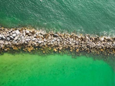 aerial view of the jetties at Alabama Point, a great snorkeling spot in Orange Beach.