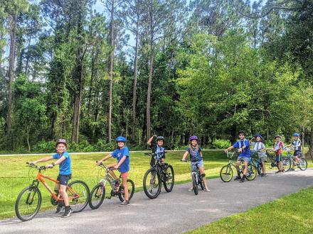 Kids riding a bike during a summer camp with the Eco-Center in Gulf Shores