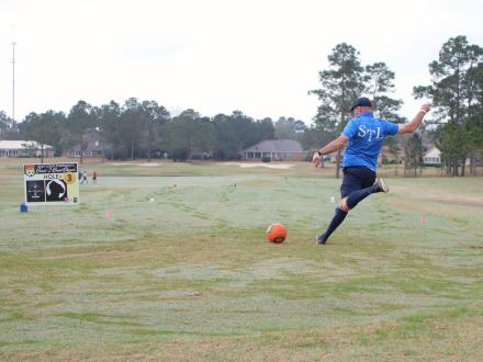 Man kicking a soccer ball during foot golf at GlenLakes golf course in Foley