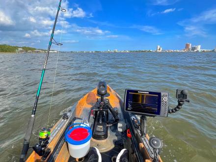 Kayak rigged with fishing equipment sitting in the calm waters of Little Lagoon