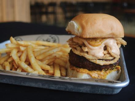 Giant burger and French fries at Luna's restaurant in Orange Beach