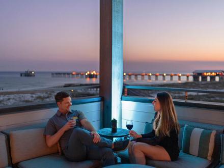 Couple dining on the deck at Perch restaurant at The Lodge