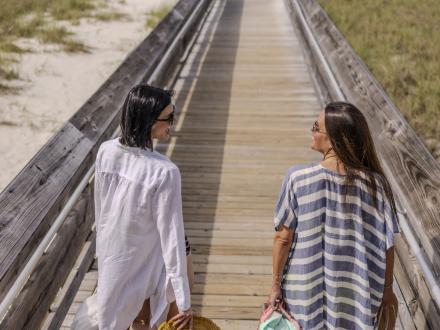Girlfriends walking toward the beach for a fun down on Alabama's Beaches