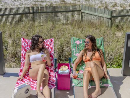 Girlfriends relaxing by the pool at their vacation rental on Alabama's Beaches