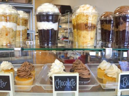 Cupcakes and jar cakes on the counter at A Specialty Bakery in Gulf Shores
