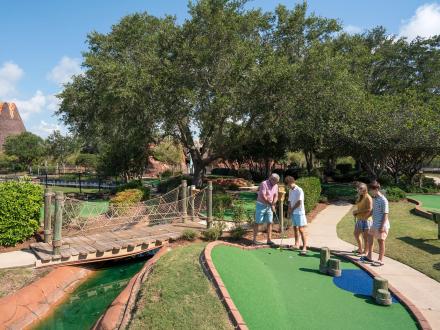 Family playing mini golf at Adventure Island in Orange Beach