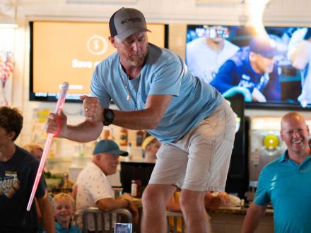 Man dancing on top of a table at Hangout beachfront restaurant in Gulf Shores