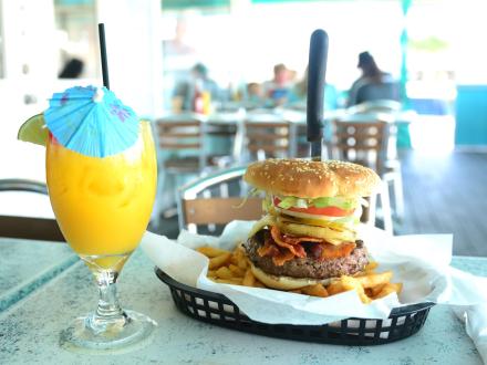A giant burger and beach cocktail at Bahama Bob's beachfront restaurant in Gulf Shores
