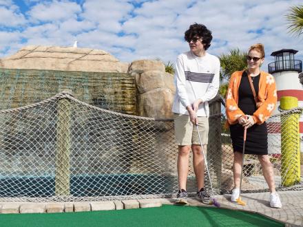 Couple playing mini golf at Beachside Mini Golf in Orange Beach