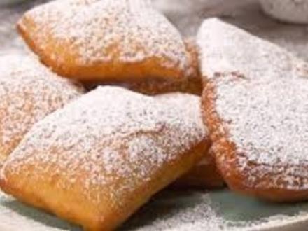 a plate of fresh powdered beignets at Cafe Beignet in Orange Beach