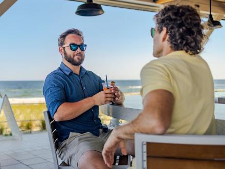 Two men sitting at the bar at Coastal