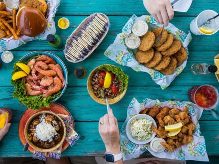 Teal picnic table filled with food at LuLu's waterfront restaurant