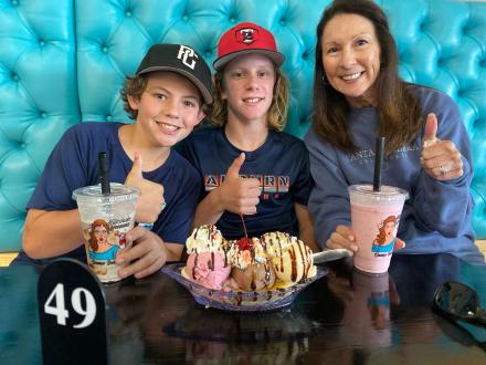 Family seated at a booth enjoying milkshakes and ice cream at Milkshake Momma in Orange Beach