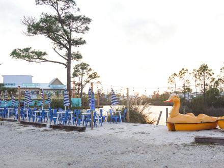 Outdoor seating area at High Tide Daiquiris & Mimosas waterfront bar in Gulf Shores