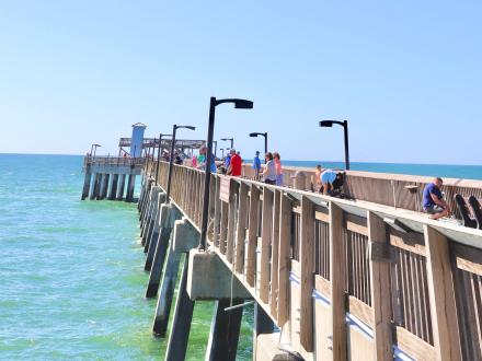 People walking down the Gulf State Park Fishing pier in Gulf Shores