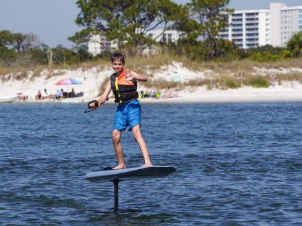 Boy foil boarding on the water in Orange Beach