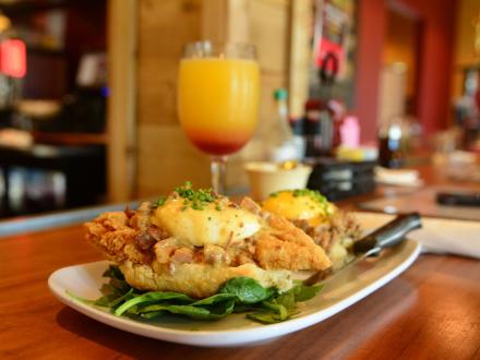 Plate of eggs Benedict and a mimosa at Ruby Slipper brunch restaurant in Orange Beach