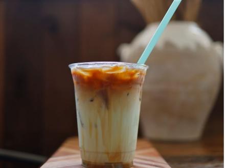 Cup of iced coffee sitting on a table at Southern Grind coffee shop in Orange Beach