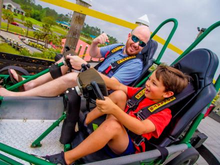 Father and son driving a go-kart at The Track Family Fun Park in Gulf Shores