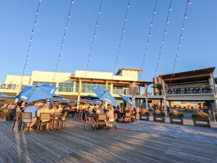 Outdoor seating deck at Zeke's waterfront restaurant in Orange Beach