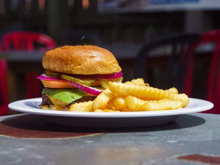 a big, juicy burger and fries at The Cove, local dive bar in Gulf Shores