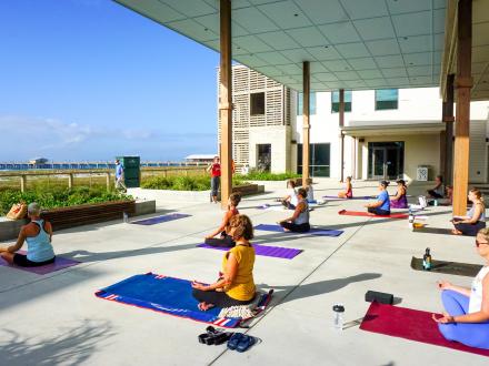 People doing yoga with Glow Yoga on the outdoor patio at The Lodge