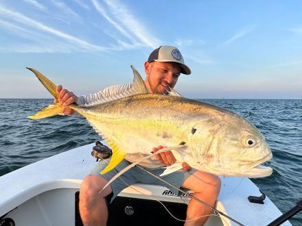 angler holing a large jack crevalled caught in the Gulf while inshore fishing in Orange Beach