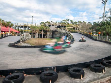 go-karts zipping around the course at The Track Family Fun Park in Gulf Shores