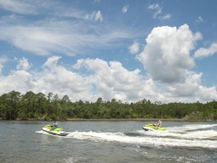 Jet skis riding across the waters of the backbars in Orange Beach