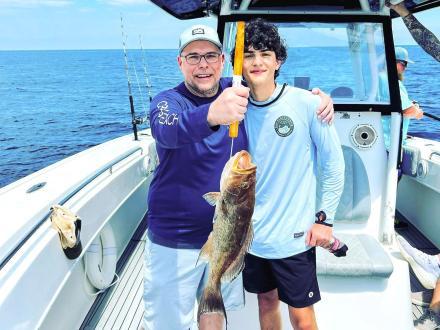 Dad and son on a fishing charter trip in Orange Beach