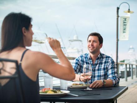 Couple dining by The Wharf Marina at Ginny Lane restaurant
