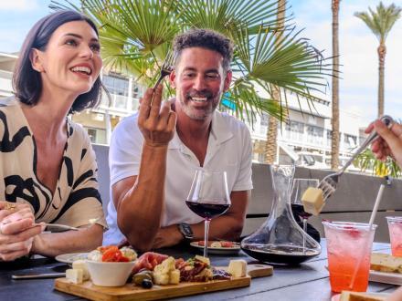 Family sharing a charcuterie board at Villaggio Grille Italian restaurant in Orange Beach