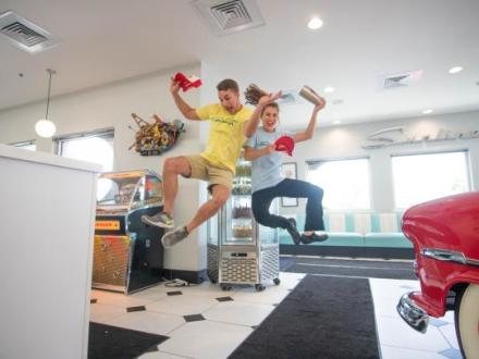 people jumping for a photo in Sunliner Diner, 50s themed beach restaurant in Gulf Shores