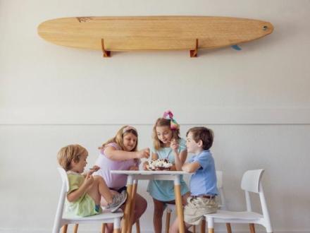 children sharing a banana split at a table at Del's, a local ice cream shop in Orange Beach