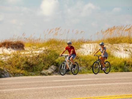 couple biking along the beach road in Gulf Shores
