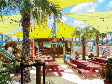 Backyard beach outdoor seating area at Moe's barbecue restaurant in Orange Beach