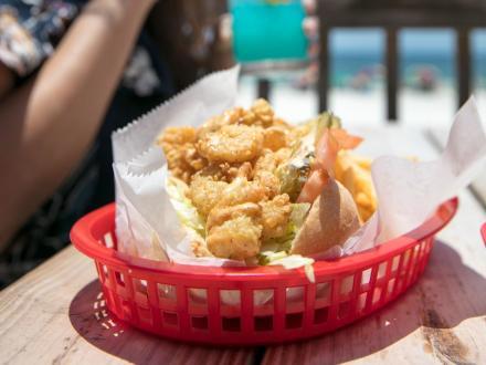 fried shrimp po'boy basket at Pink Pony Pub beachfront restaurant in Gulf Shores
