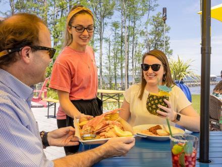 Couple dining on the outdoor patio at GTs waterfront restaurant in Orange Beach