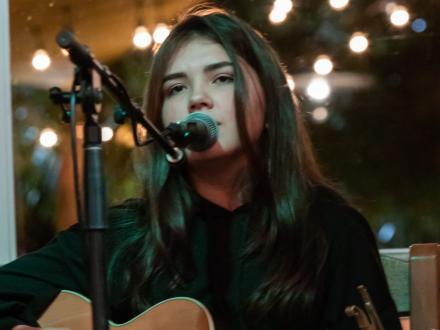 Singer performing live music at LuLu's waterfront restaurant