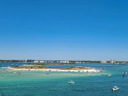 Boats cruising in turquoise waters around the islands in Orange Beach