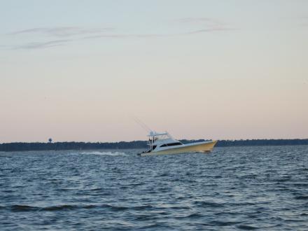 Boat cruising through the waterways of Alabama's Beaches at sunset