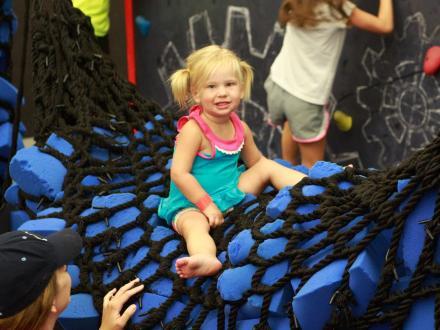 little girl playing in the foam pit at The Factory Trampoline Park in Gulf Shores