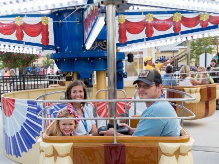 Family riding a fun children's ride at Tropic Falls Theme Park