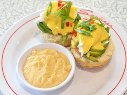 a yummy plate with avocado benedict and a bowl of grits at Sunliner Diner