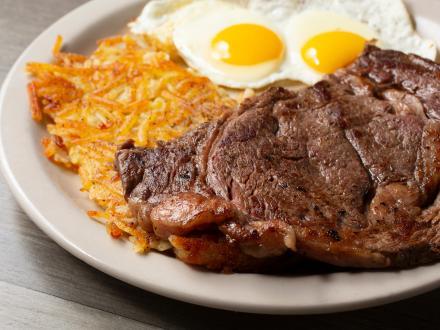 a plate of steak, eggs, and hash browns
