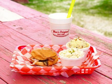 a plate of delicious Moe's Alabama barbecue on a picnic table