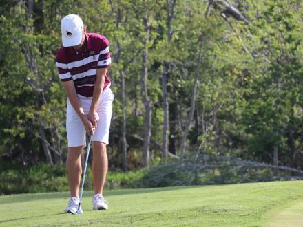 Golfer teeing up on a coastal golf course in Gulf Shores