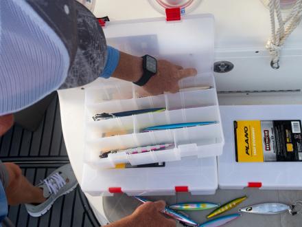 Hand reaching into a tackle box