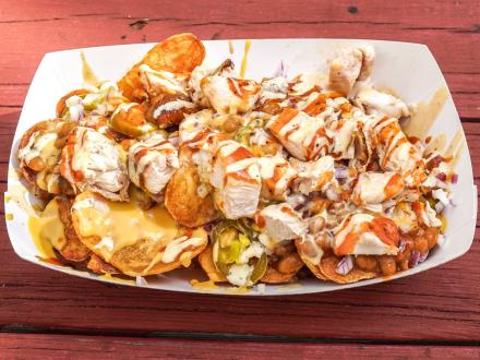 a tasty basket of barbecue chicken nachos made with housemade chips at Moe's Bar B Que in Orange Beach
